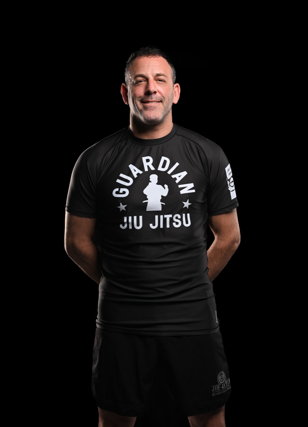 Studio portrait of a martial artist wearing a black rashguard
