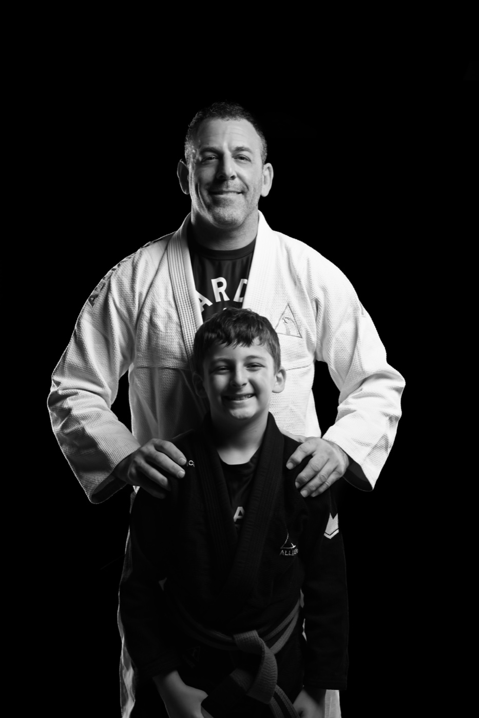 Black-and-white portrait of a father and son in Jiu-Jitsu gis